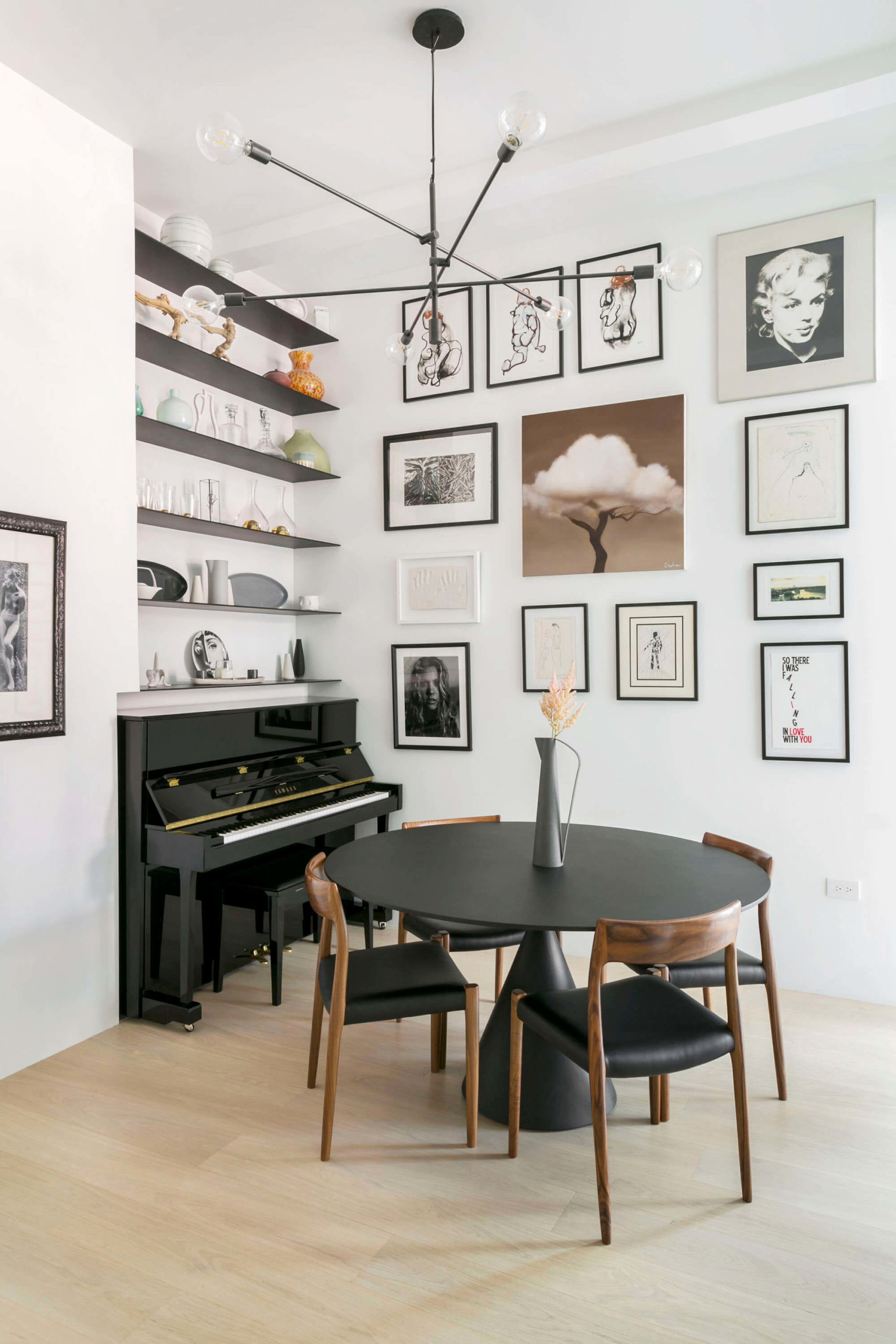 dining area with gallery wall and open shelves above a piano