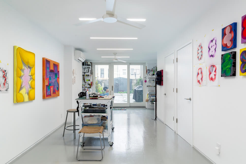 Display of art work in a white art studio and work station