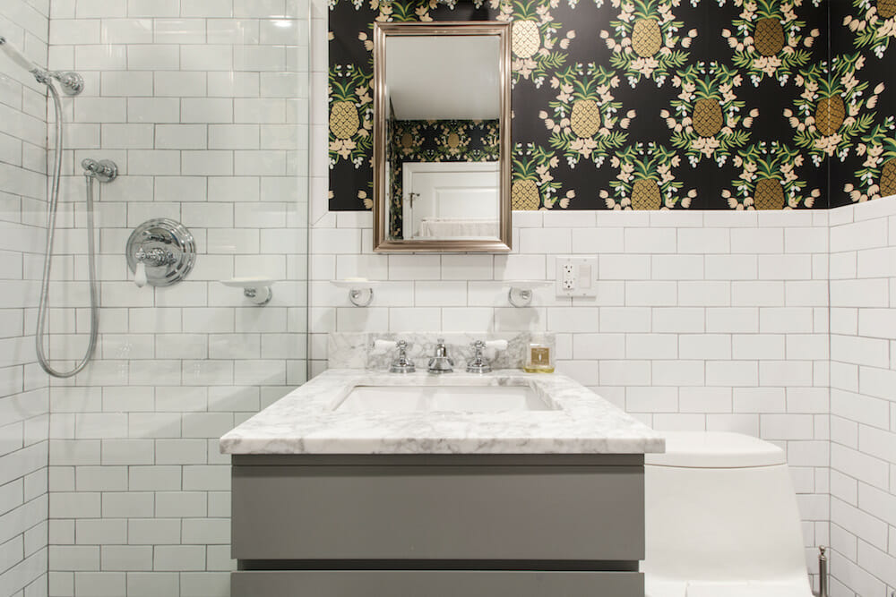 bathroom with subway tile and wallpaper