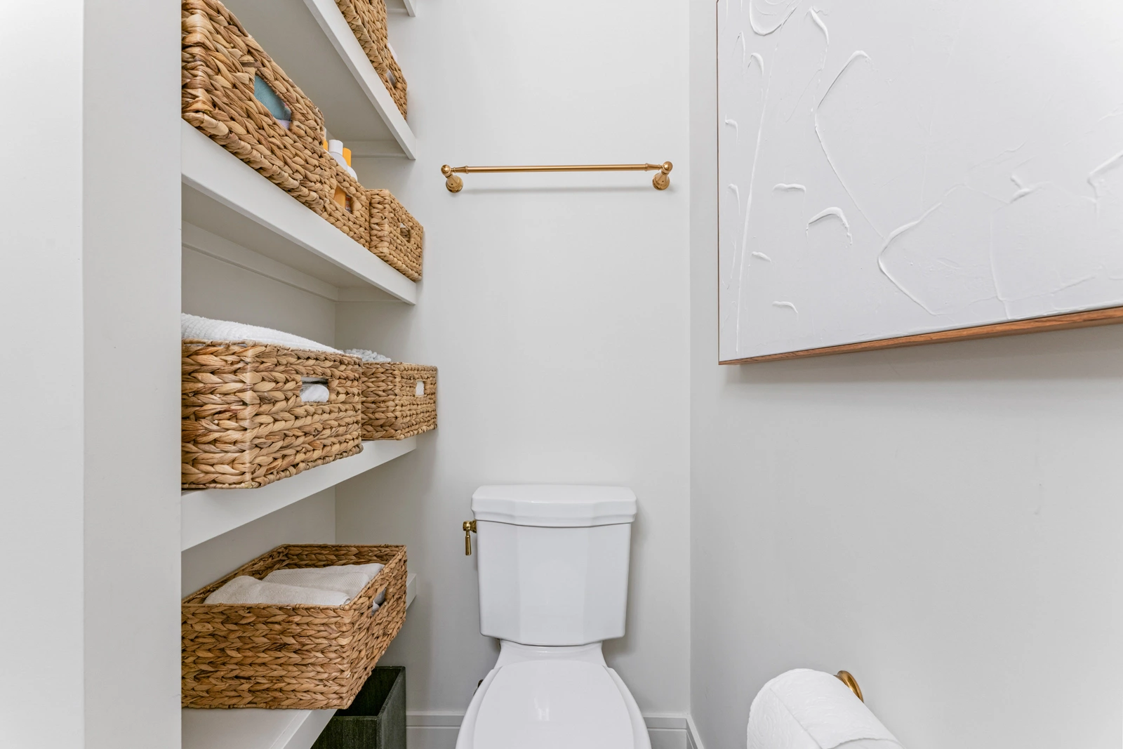 built in storage shelves and toilet