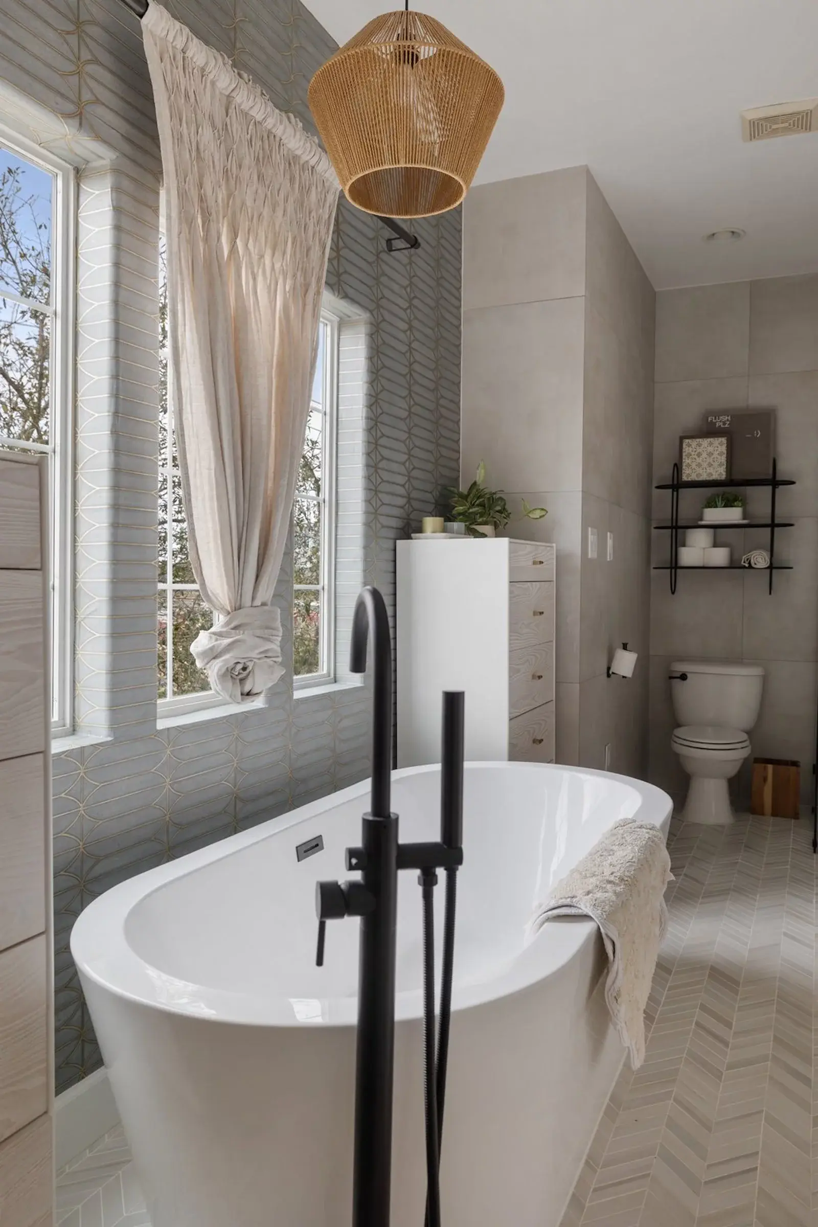 soaking tub with floor mount tub filler in black finish in bathroom remodel in houston