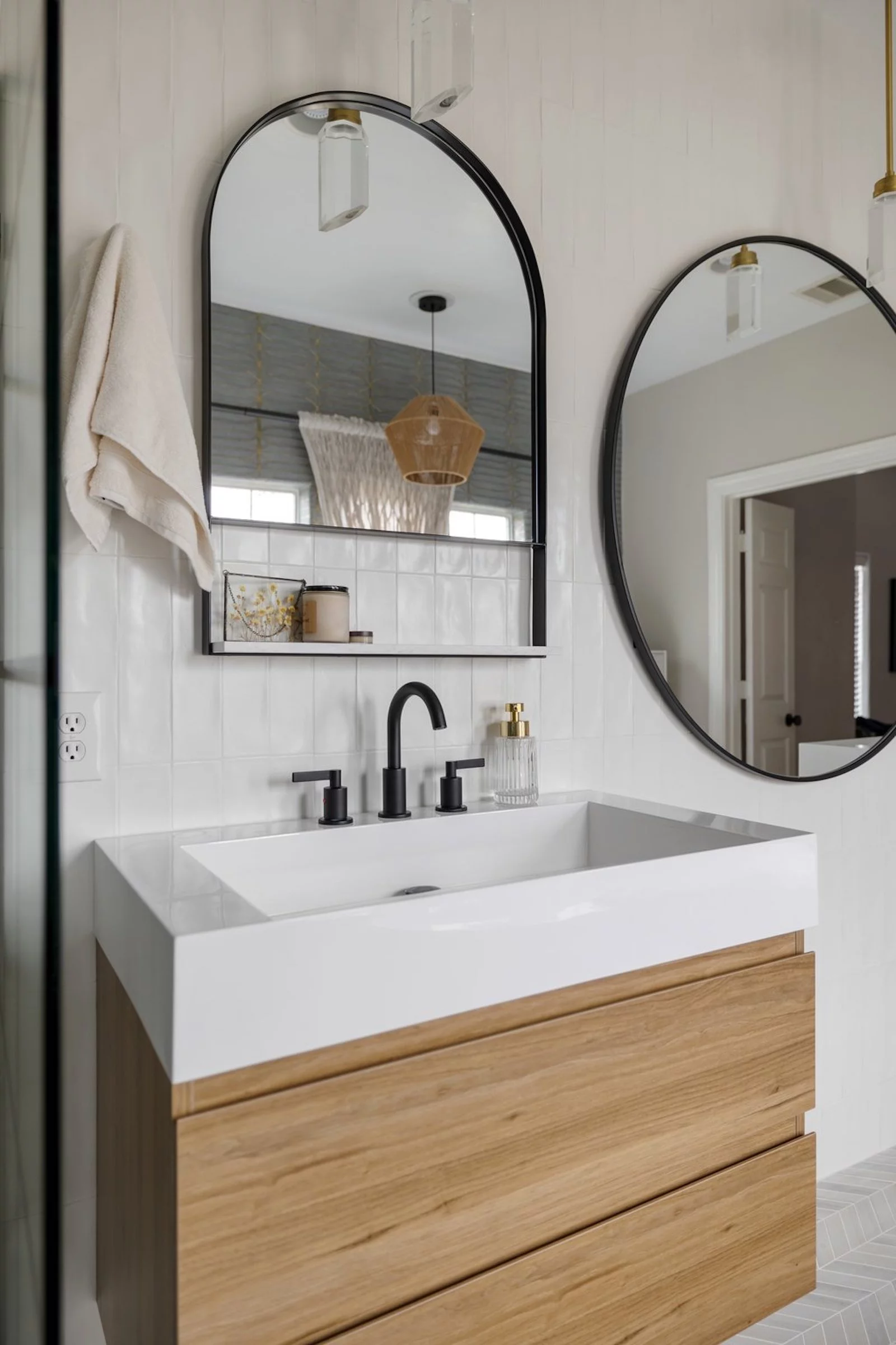 wall hung wood vanity with white countertop sink and black fixtures